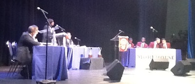 Students from the Morehouse College debate team confer during an argument by Howard’s Gavette Richardson.