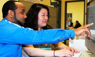 LaGuardia Community College student (right) gets assistance from college staff member (photo courtesy of LaGuardia Community College)