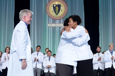 Asia and Ashley Matthew embrace at their white coat ceremony at UMass medical school.