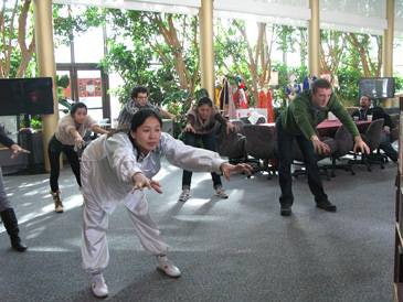 You Zhou teaches a Chinese stretching exercise at the Community College of Denver’s Confucius Institute.