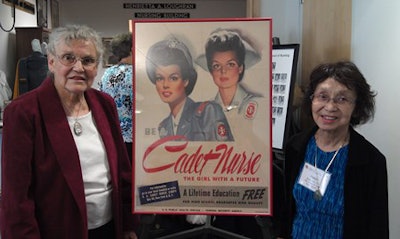 (Left) College of Nursing alumnae Thelma Robinson and Helen Nakagawa Budzynski stand next to a “Cadet Nurse” poster from the World War II period.