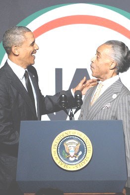 President Obama, left, told Rev. Al Sharpton’s civil rights group that the future of voting rights is in grave danger.