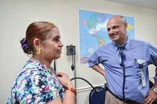 In the Denver area, Dr. Jamaluddin Moloo, right, co-founded a primary care clinic for refugees in 2012, called the Colorado Refugee Wellness Center.