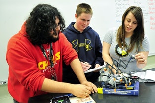 San Jacinto College math students, from left, Miguel Rosales, Harrison Mast and Darby Macha, participate in a robotics lab during Tech Friday.