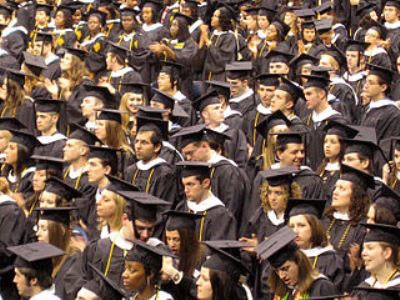 College graduates prepare to walk across the stage