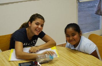 A Miami-Dade College student (left) volunteers with Pages for All Ages. (Photo by Jessyca Perez)