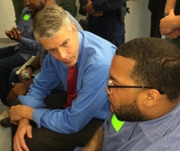 U.S. Secretary of Education Arne Duncan talks with an inmate at the Maryland Correctional Institution-Jessup about his participation in the Goucher Prison Education Partnership Program.