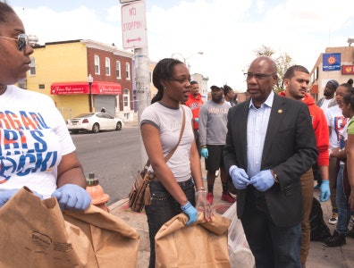 Morgan State President David A. Wilson joins with students in community cleanup efforts in the wake of Freddie Gray’s death. Wilson said Morgan State has a responsibility to help solve the issues of the community.
