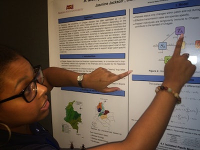 Jasmine Jackson, a second-year Ph.D. student of applied mathematics at Arizona State University, shows her poster that details the threat of the deadly “kissing bugs,” which have been spotted in certain parts of the United States.