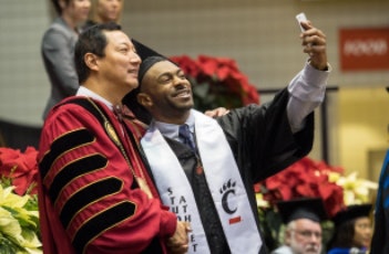 University of Cincinnati President Santa J. Ono, left, poses for a photo with a student. (Photo courtesy of the University of Cincinnati)