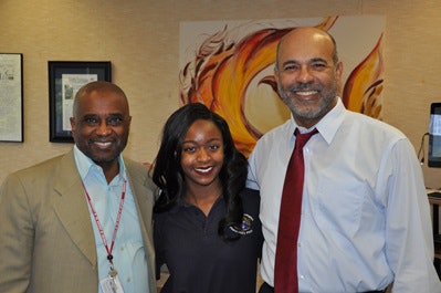 Jalia Johnson is flanked by UDC President Mason and COO Troy A. Lamaile-Stovall. Jalia was the first DC student to accept a DC-UP scholarship.