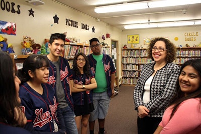 Dr. Bianca Guzman, second from right, stands with students at Garfield High School. (Photo courtesy of Cal State L.A. Office of Communication and Public Affairs)