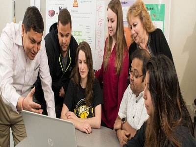 Professor Anupam Joshi, left, collaborates with his students at the University of Maryland, Baltimore County.