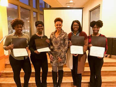 Gina Paige, co-founder and CEO of AfricanAncestry.com, (center) stands flanked by University of Maryland, Baltimore students who just learned their ancestral homelands through genetic tests conducted by Paige’s company. The students are, from left to right: Maia Wise, Shannah Edmonds, Jasmine Whitcomb and Tahrea Flemming.