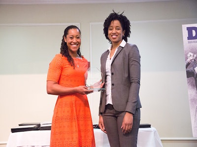 Nicole Evans, left, accepts a plaque recognizing her as the female winner of the 2017 Arthur Ashe Jr. Scholar Athlete award. Sonja Robinson, NCAA director of minority inclusion, presented the award as selected by Diverse at a luncheon Tuesday at the University of Richmond. (Photo by Kim Schmidt)