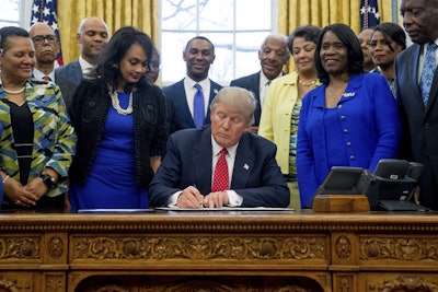 President Donald Trump signs the Historically Black Colleges and Universities HBCU Executive Order, Tuesday, Feb. 28, 2017, in the Oval Office in the White House.