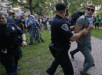 Police remove a protester during a rally to remove the confederate statue known as Silent Sam from campus at the University of North Carolina in Chapel Hill. (AP Photo/Gerry Broome)