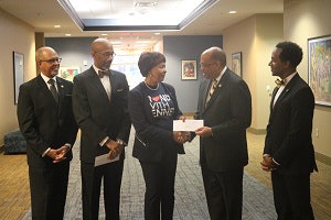 Dr. Everett B. Ward hands Dr. Phyllis Worthy Dawkins a check in support of Bennett College.