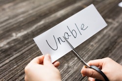 holds card with text unable on old wood plank