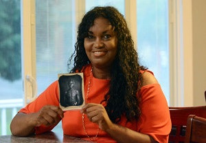 Tamara Lanier, holding an image of her great-great-great grandfather, Papa Renty.