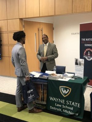 A representative from Wayne State Law School talks to a prospective applicant.