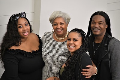 Patricia Newell (center) directs the Phasing Up-Guardian Scholars Program at Johnson C. Smith University. Jayrah Topey (left), Jazmyn McQuarter and Tristan Gunn are among the program’s graduates and students who call her ”Mama Newell.“