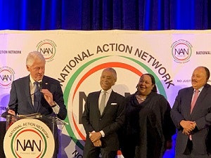 Former President Bill Clinton accepts an award given by Rev. Al Sharpton. Next to Sharpton is AT&T executive Tonya Lombard and Martin Luther King III, the son of the slain civil rights leader.