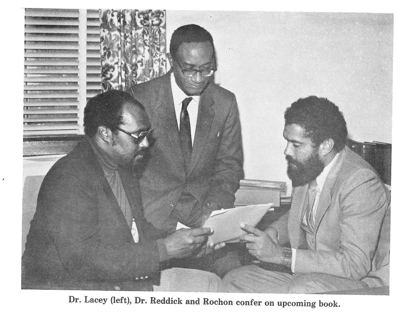 Dr. Lawrence D. Reddick, middle, confers with colleagues on a book project.