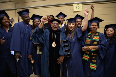 Dr. Charlene Dukes celebrates with students at their 2019 commencement ceremony.