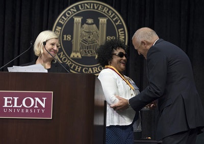 Janice Ratliff, center, receiving the Elon Medallion in 2017.