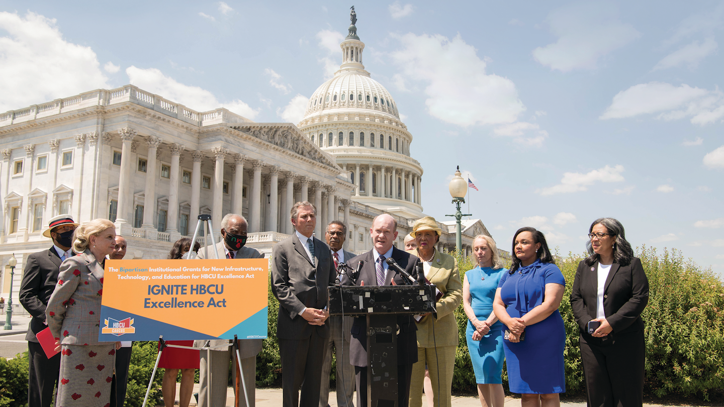 Sen. Chris Coons speaks at the IGNITE announcement in Washington, D.C., with Rep. Alma Adams standing behind him.