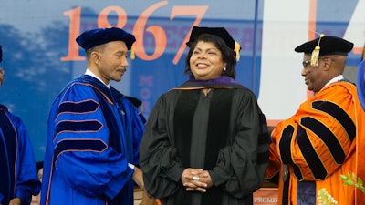 April Ryan with MSU Board of Regent Chair Congressman Kweisi Mfume (left) and MSU President David K. Wilson as she receives an honorary Doctor of Laws degree at Morgan Commencement Ceremony in 2017.