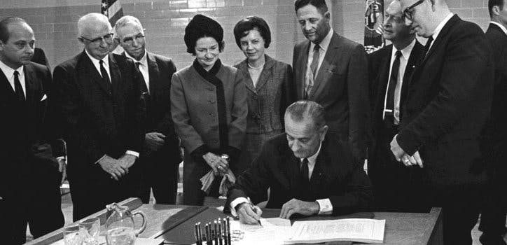 President Lyndon B. Johnson signs the Higher Education Act of 1965