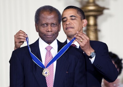 Former President Barack Obama presents Sidney Poitier with the Presidential Medal of Freedom.