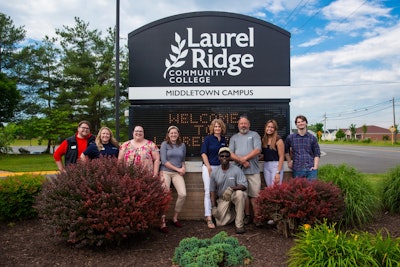 Staff at Laurel Ridge Community College's Middletown Campus stand next to their new sign. The college changed its name on June 3, from Lord Fairfax Community College.