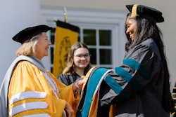 Dr. Pamela R. Fox congratulates a doctor of occupational therapy graduate during a 2023 commencement ceremony.