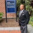 Joseph Stewart standing in front of Isaac Hawkins Hall at Georgetown University, named after his ancestor.