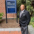 Joseph Stewart standing in front of Isaac Hawkins Hall at Georgetown University, named after his ancestor.