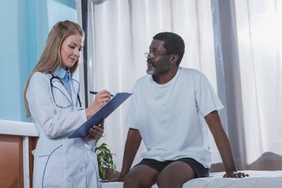 Stock Photo Doctor Writing Down Something To Clipboard