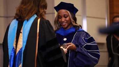 Dr. Christa Mahlobo is honored at a ceremony recognizing her attainment of a Ph.D. in human development from The Pennsylvania State University.