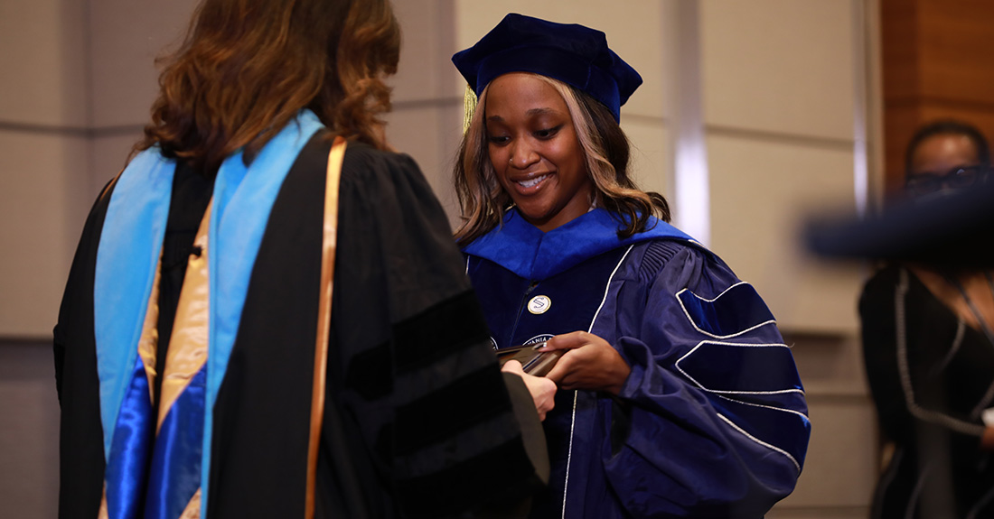 Dr. Christa Mahlobo is honored at a ceremony recognizing her attainment of a Ph.D. in human development from The Pennsylvania State University.