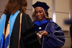 Dr. Christa Mahlobo is honored at a ceremony recognizing her attainment of a Ph.D. in human development from The Pennsylvania State University.