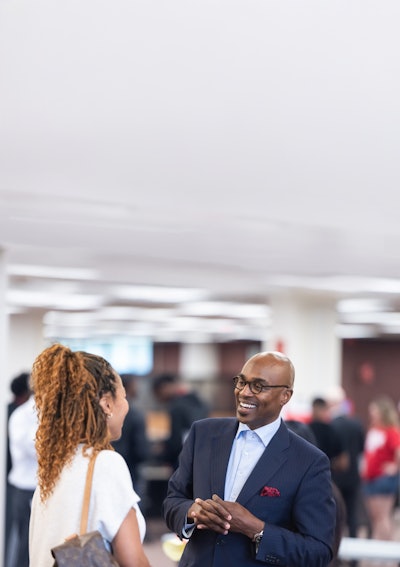 Dr. James Minor talking to a SIUE student.